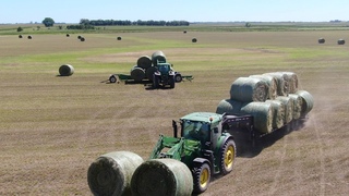 Tractors moving Alfalfa in South Dakota